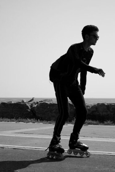 Silhouette of a man roller skating near the Istanbul coastline in black and white.